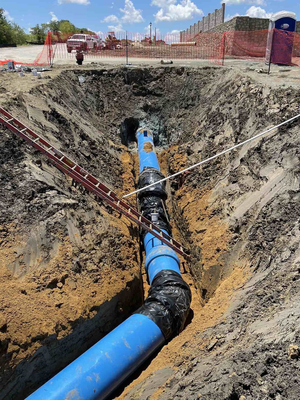 Water line installation in a trench at the Marilee water project