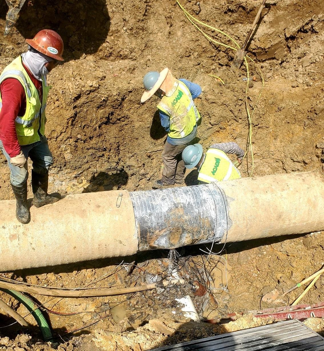 Crew working on an exposed pipe during the Lantana emergency repair
