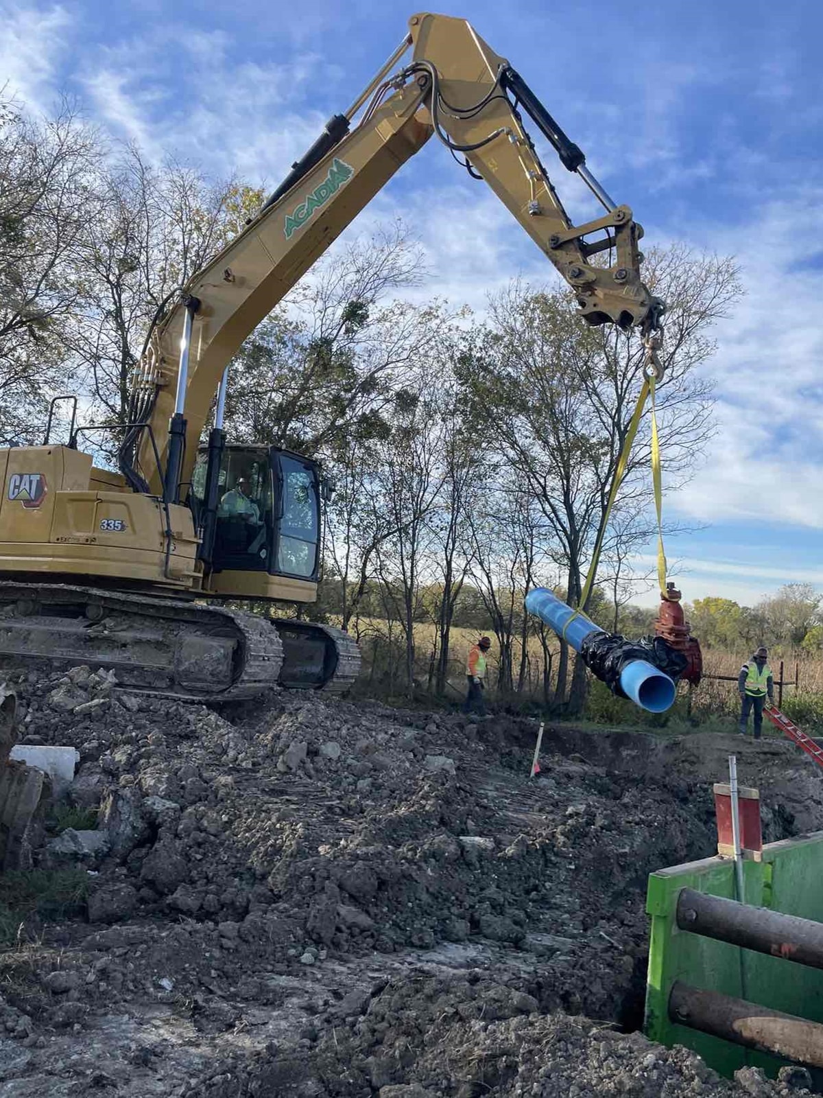 Excavator rehabilitating an existing utility line