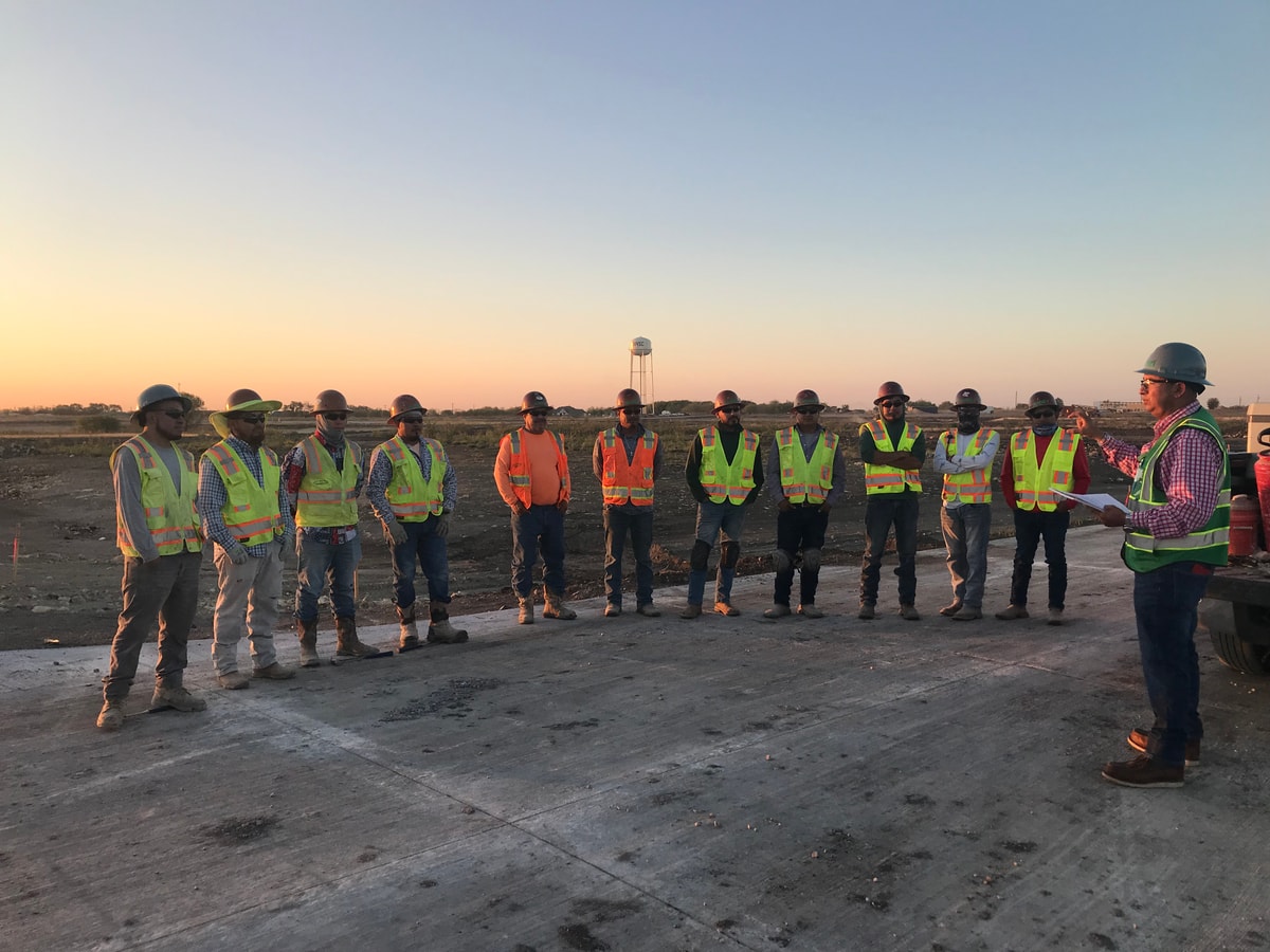 Acadia crew in a morning safety meeting at sunrise