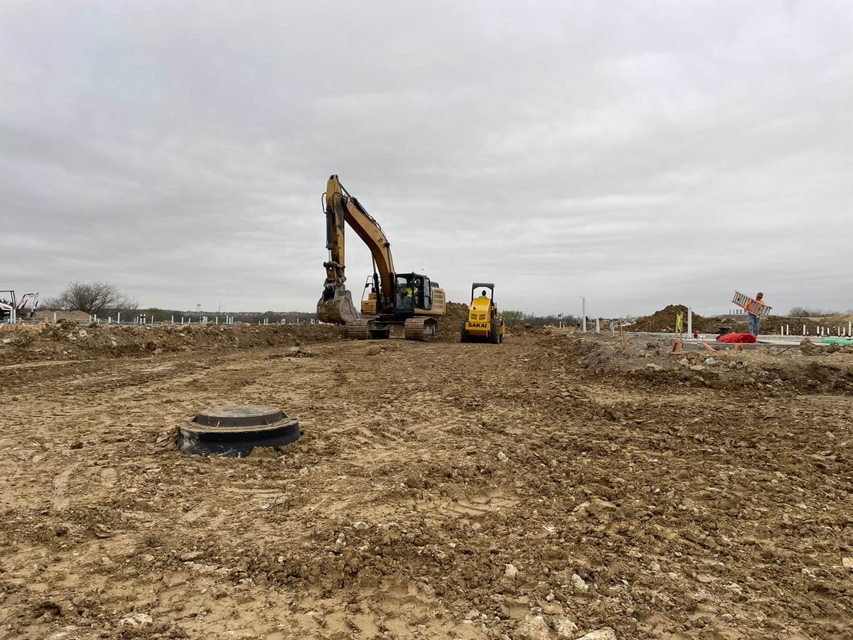 Excavator on the Mansions at Marine Creek site