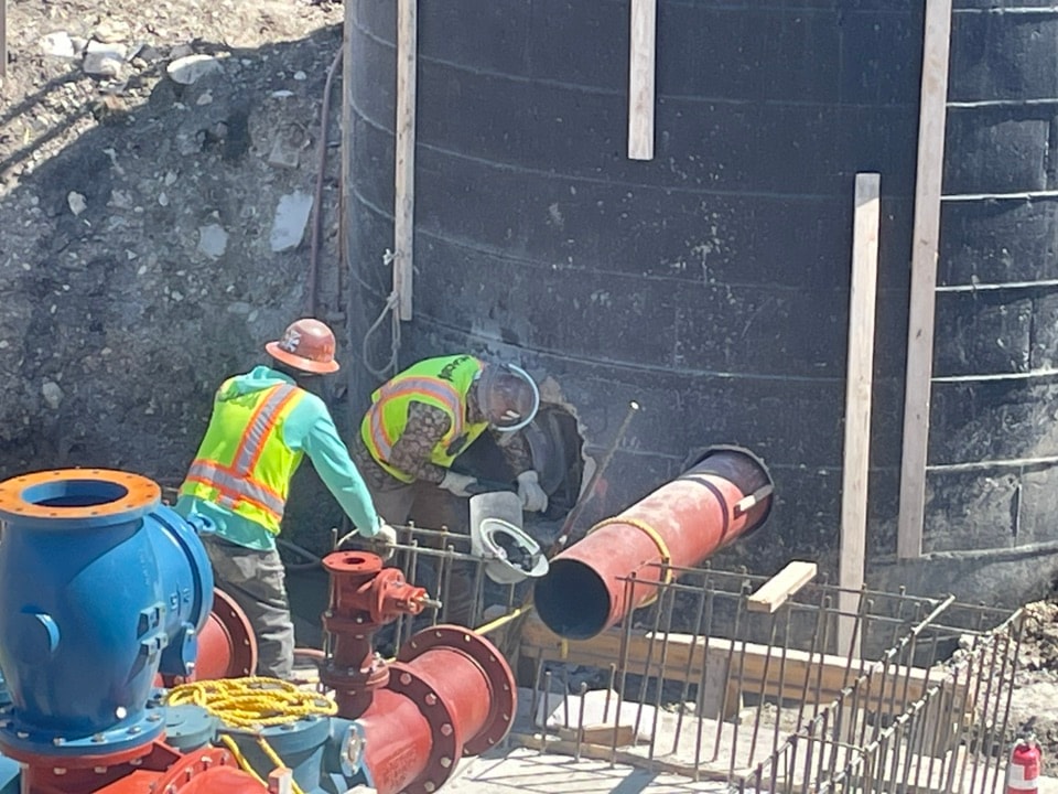 Crew assembling lift station piping at Hickory Grove Phase